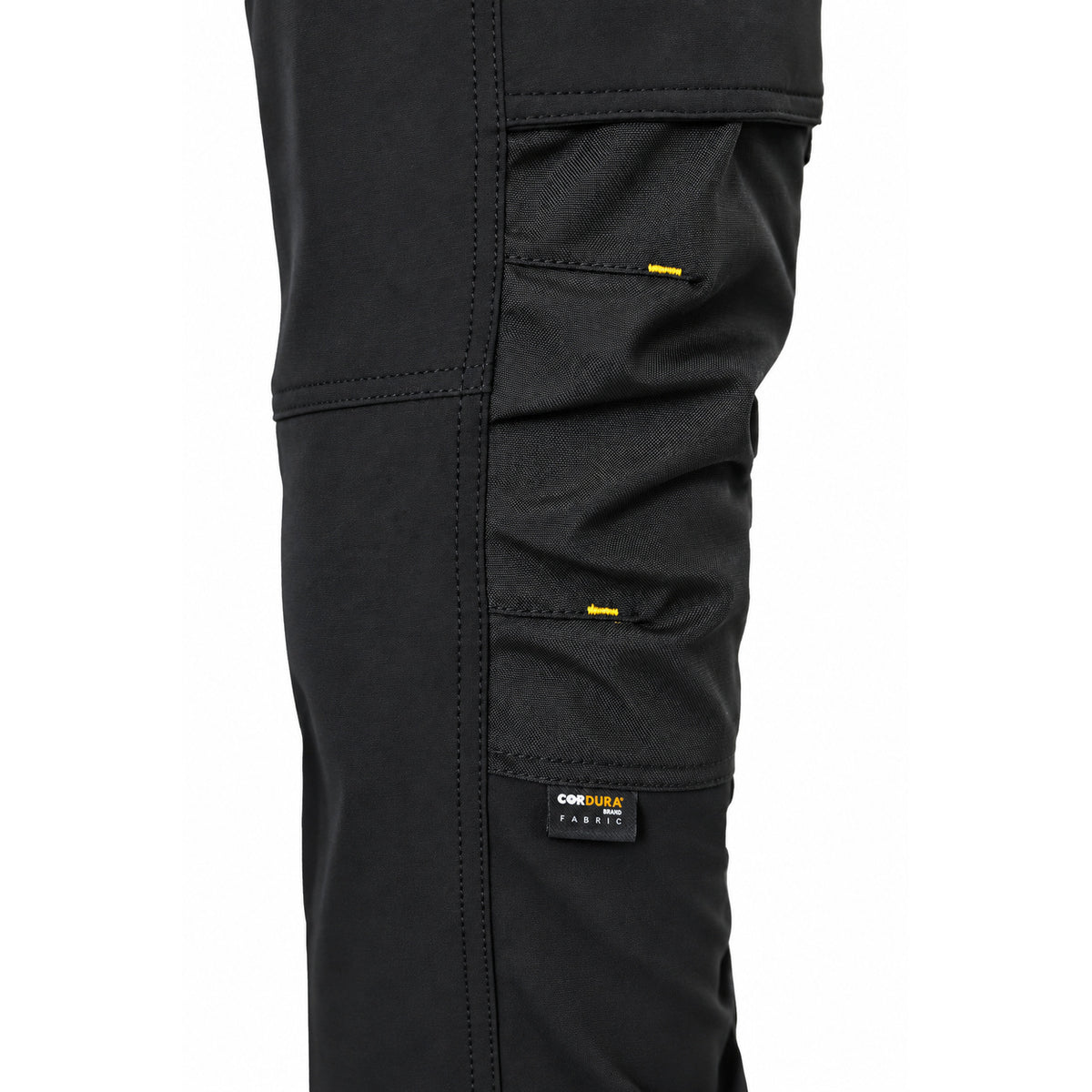 Close-up of reinforced CORDURA knee panel on black ATOMIC work trousers with yellow bar-tack stitching.
