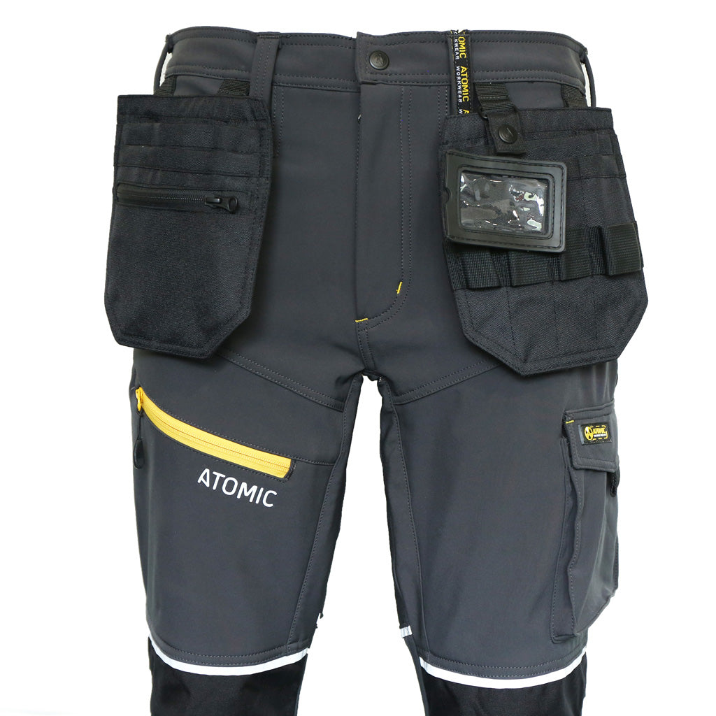 Gray work pants with multiple pockets and 'Atomic' branding on a white background